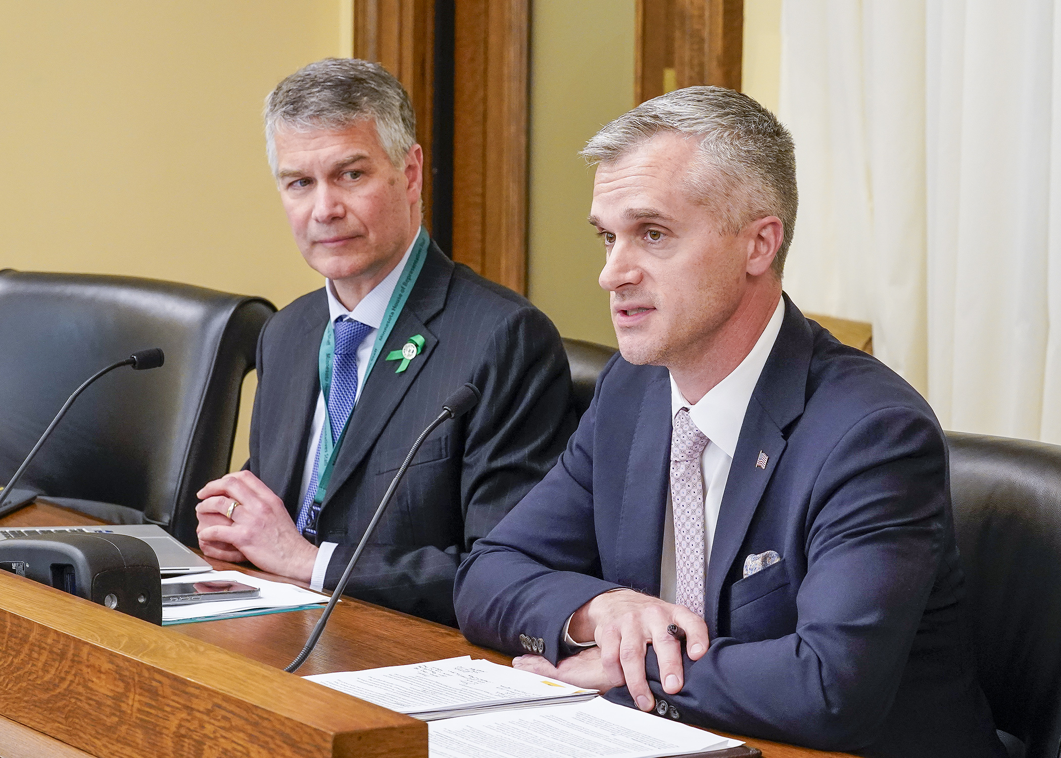 Luke Gaalswyk, president and CEO of Ever-Green Energy, testifies before the House Energy Finance and Policy Committee April 14 in support of a bill sponsored by Rep. Larry Kraft, left, to provide funding for a wastewater treatment facility heat capture pilot program. (Photo by Andrew VonBank)
